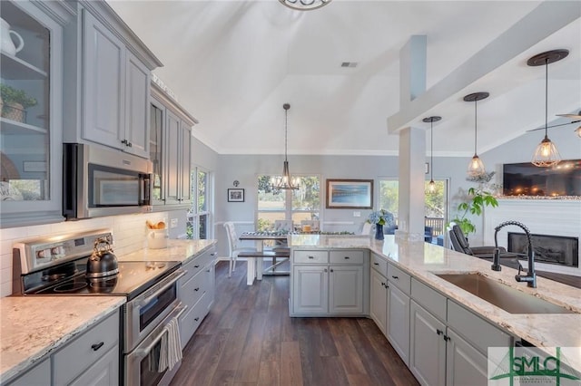 kitchen featuring gray cabinets, appliances with stainless steel finishes, and a sink