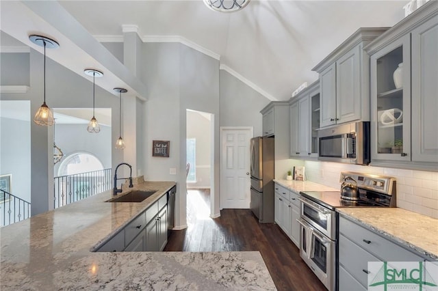 kitchen with crown molding, gray cabinets, appliances with stainless steel finishes, and a sink