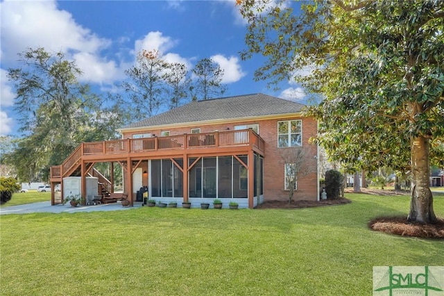 back of house with stairs, a lawn, brick siding, and a sunroom