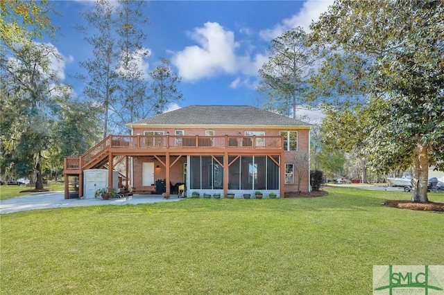 back of house featuring a garage, a lawn, stairs, and a sunroom