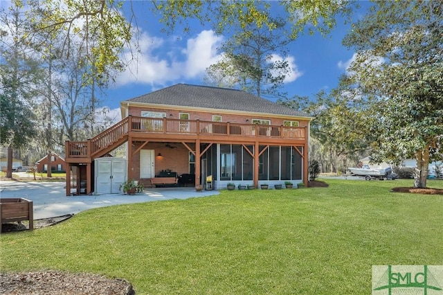 back of house featuring a lawn, a wooden deck, a patio, and a sunroom