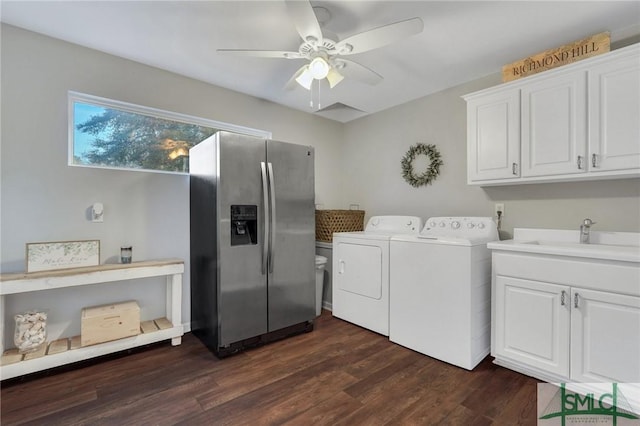 clothes washing area with ceiling fan, washer and clothes dryer, dark wood-style floors, cabinet space, and a sink