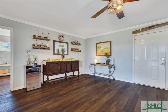 entrance foyer with baseboards, wood finished floors, and ornamental molding