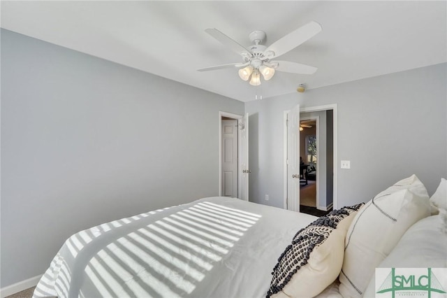 bedroom with baseboards and a ceiling fan