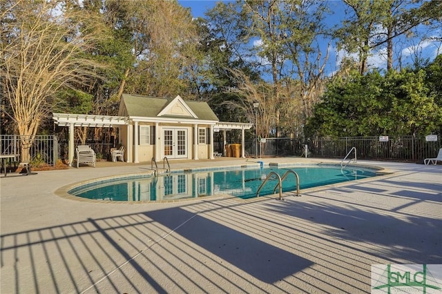 community pool featuring a patio area, fence, a pergola, and french doors