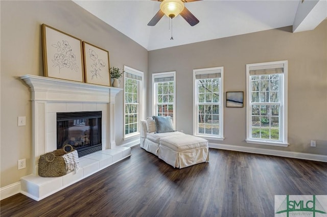 living area with plenty of natural light, baseboards, and wood finished floors