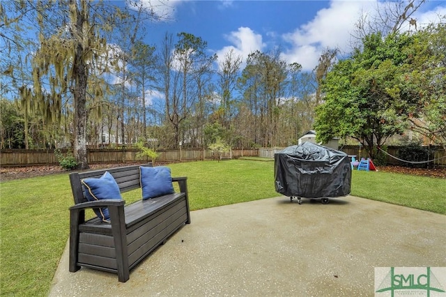 view of patio with area for grilling and a fenced backyard