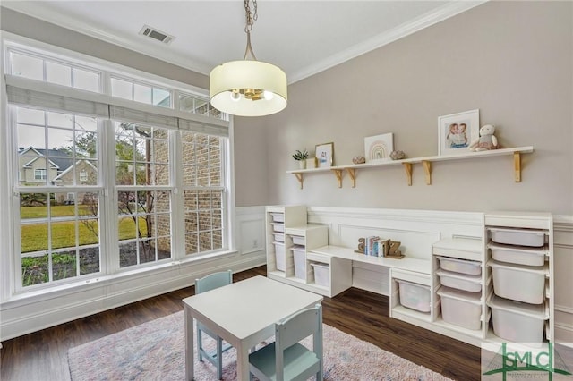 sitting room featuring visible vents, wainscoting, wood finished floors, and ornamental molding