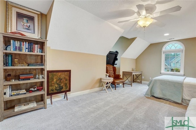 bedroom featuring visible vents, baseboards, lofted ceiling, carpet flooring, and a ceiling fan