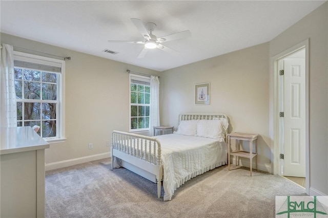 bedroom featuring carpet flooring, visible vents, a ceiling fan, and baseboards