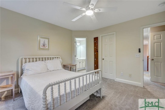 bedroom with connected bathroom, baseboards, carpet, and a ceiling fan