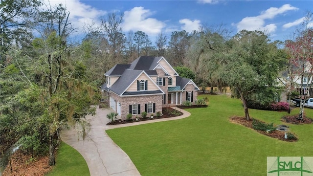 view of front of home with a front yard, concrete driveway, and a garage