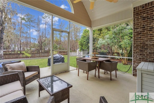 sunroom featuring ceiling fan and vaulted ceiling