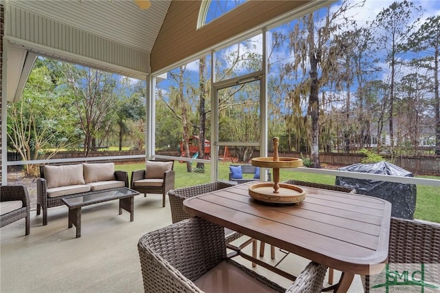 sunroom featuring vaulted ceiling