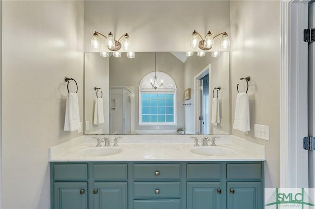 bathroom featuring a sink, lofted ceiling, a stall shower, and double vanity