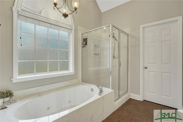 bathroom featuring tile patterned flooring, a shower stall, a jetted tub, and an inviting chandelier