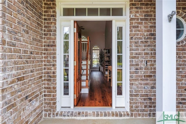 doorway to property with brick siding