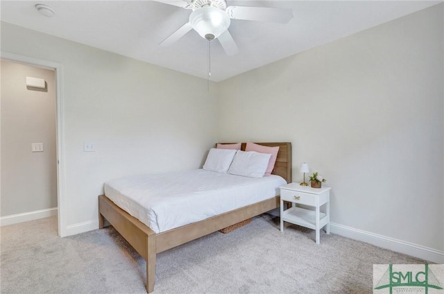 carpeted bedroom with a ceiling fan and baseboards