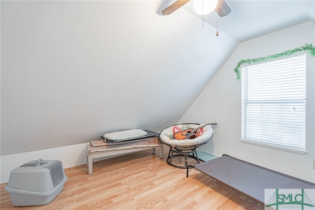 interior space with ceiling fan, wood finished floors, and vaulted ceiling