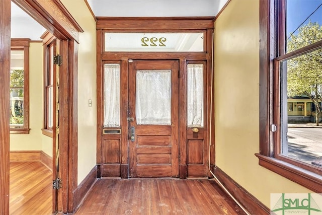 foyer entrance featuring wood finished floors and baseboards