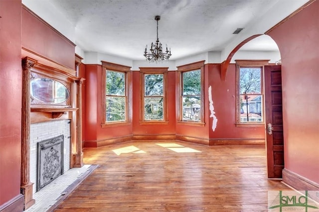 interior space featuring visible vents, plenty of natural light, and wood finished floors