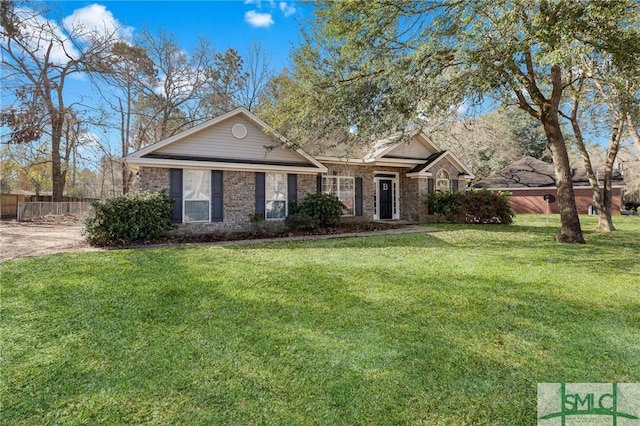 single story home featuring brick siding, a front yard, and fence