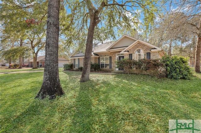 view of front of property with a front yard, brick siding, and a chimney