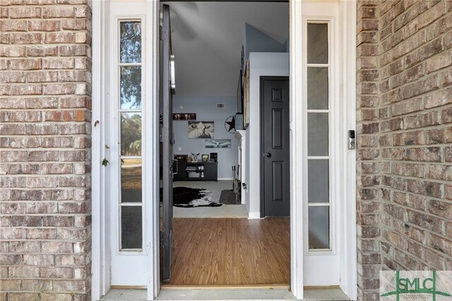 property entrance featuring brick siding