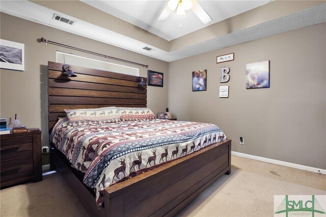 carpeted bedroom featuring visible vents, a ceiling fan, and baseboards