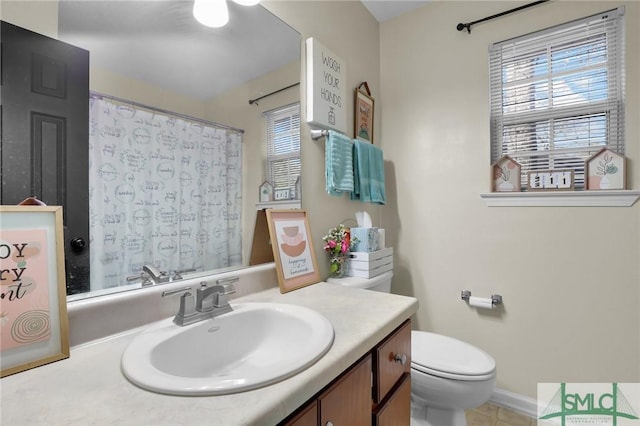 bathroom with a shower with curtain, toilet, and vanity