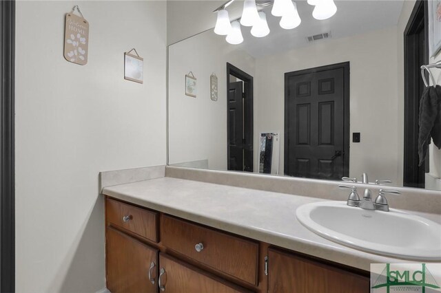 bathroom featuring vanity and visible vents