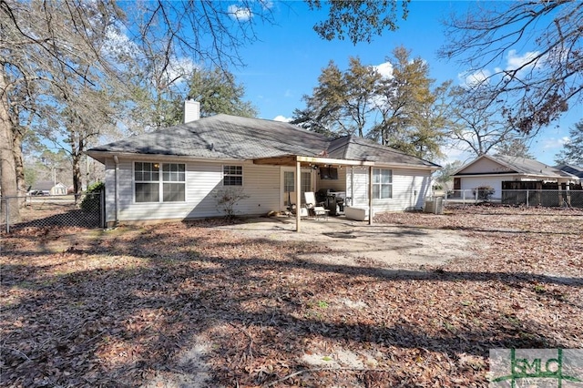 back of property featuring a patio, a chimney, and fence