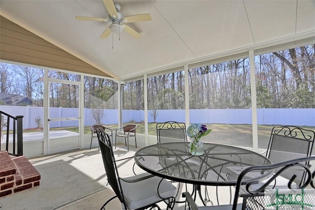 sunroom / solarium with plenty of natural light, a ceiling fan, and lofted ceiling