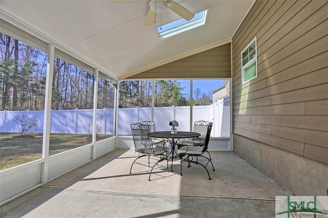 sunroom with vaulted ceiling with skylight and ceiling fan