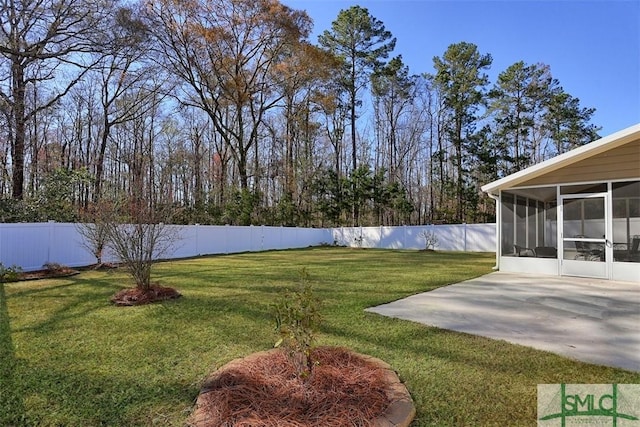 view of yard featuring a patio, a fenced backyard, and a sunroom