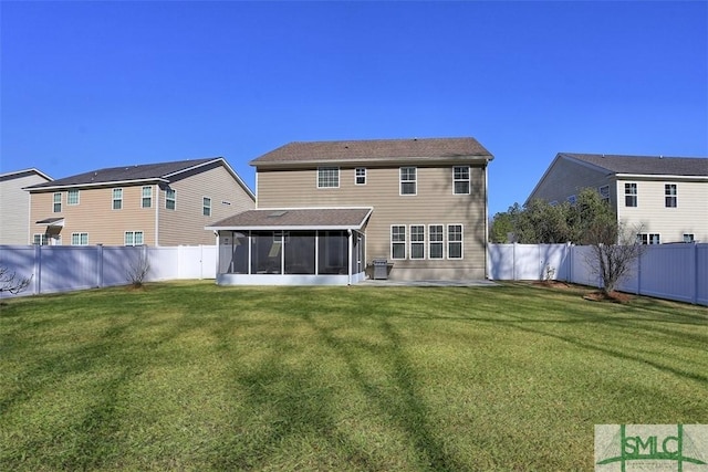 back of property with a yard, a fenced backyard, and a sunroom