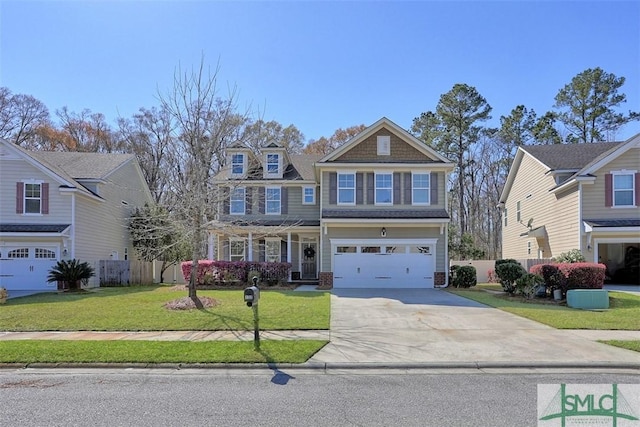 craftsman-style home with a front lawn, concrete driveway, fence, and a garage