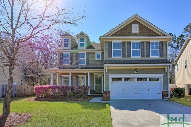 craftsman inspired home with fence, an attached garage, a front lawn, concrete driveway, and brick siding