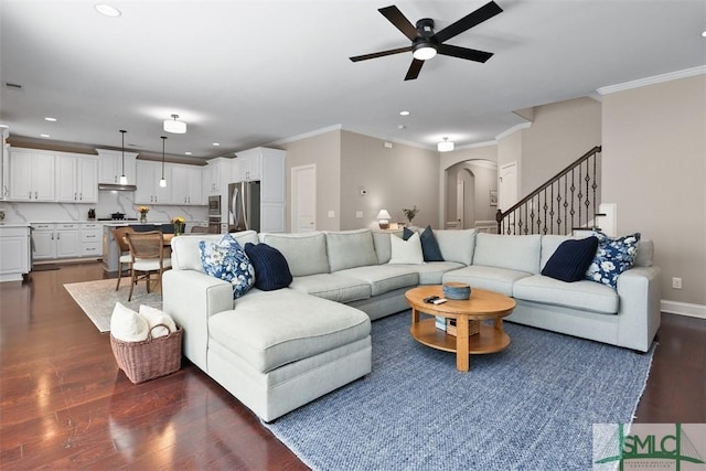 living room featuring recessed lighting, arched walkways, dark wood-style flooring, and crown molding