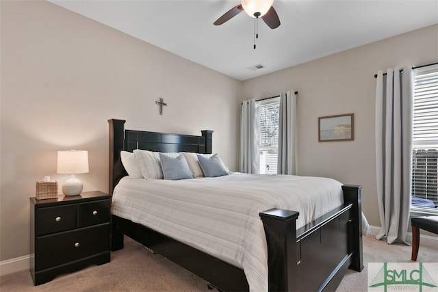 bedroom featuring light carpet, visible vents, a ceiling fan, and baseboards