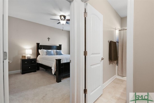 bedroom featuring baseboards, light colored carpet, and ceiling fan