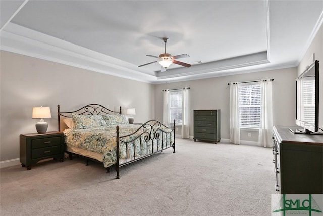 bedroom featuring a tray ceiling, carpet, baseboards, and ornamental molding