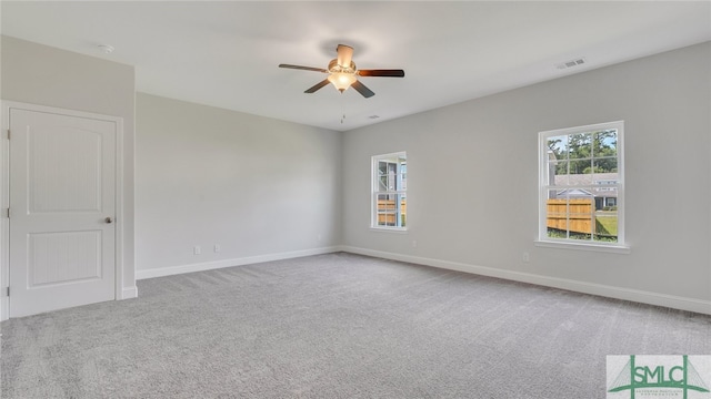 unfurnished room featuring a ceiling fan, carpet, and baseboards