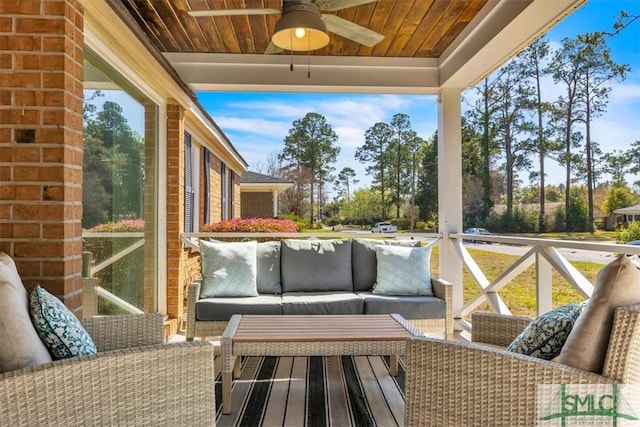 deck with outdoor lounge area and ceiling fan