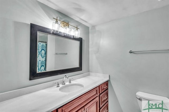 bathroom featuring toilet and vanity