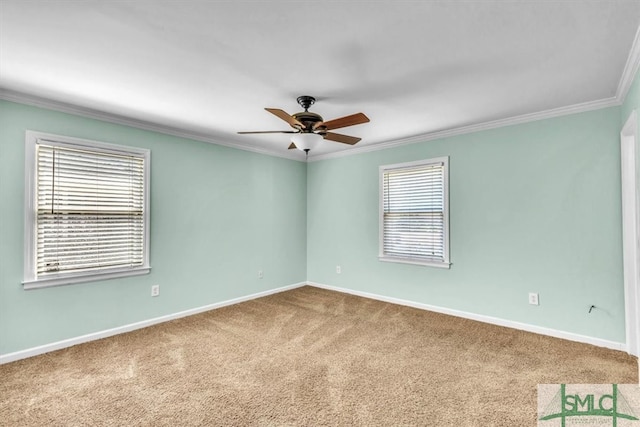 spare room with ceiling fan, carpet, baseboards, and ornamental molding