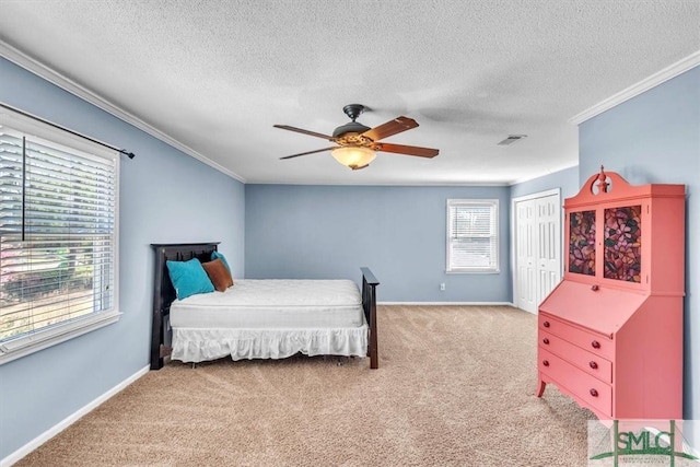 bedroom with visible vents, baseboards, a closet, crown molding, and light colored carpet