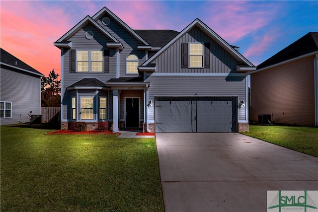 craftsman-style home with a front lawn, an attached garage, board and batten siding, and driveway