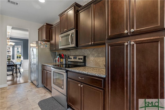 kitchen featuring light stone countertops, visible vents, stainless steel appliances, decorative backsplash, and dark brown cabinetry