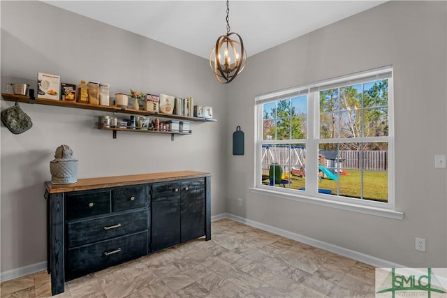 interior space with an inviting chandelier and baseboards